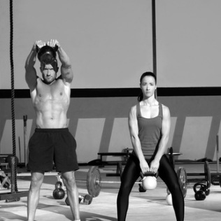 Kettlebells swing crossfit exercise man and woman